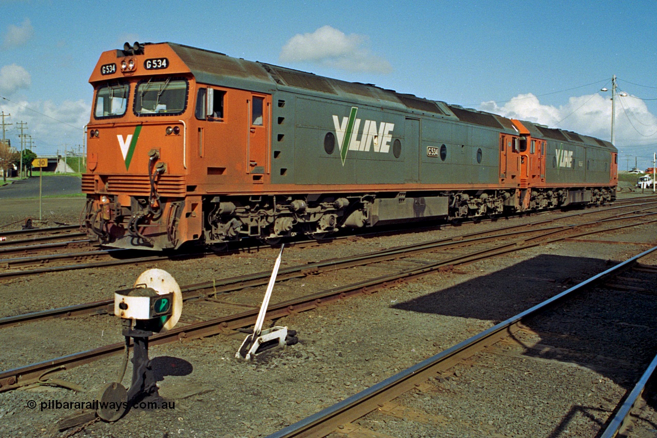 185-17
North Geelong C Box, V/Line light engines, G classes G 534 Clyde Engineering EMD model JT26C-2SS serial 88-1264 leads older sister and class leader G 511 serial 84-1239 as they shunt back into the Sorting Sidings to collect an empty grain train, ground dwarf signal post 18 and point lever for points from Through Road to No.1 Siding are in the foreground.
Keywords: G-class;G534;Clyde-Engineering-Somerton-Victoria;EMD;JT26C-2SS;88-1264;