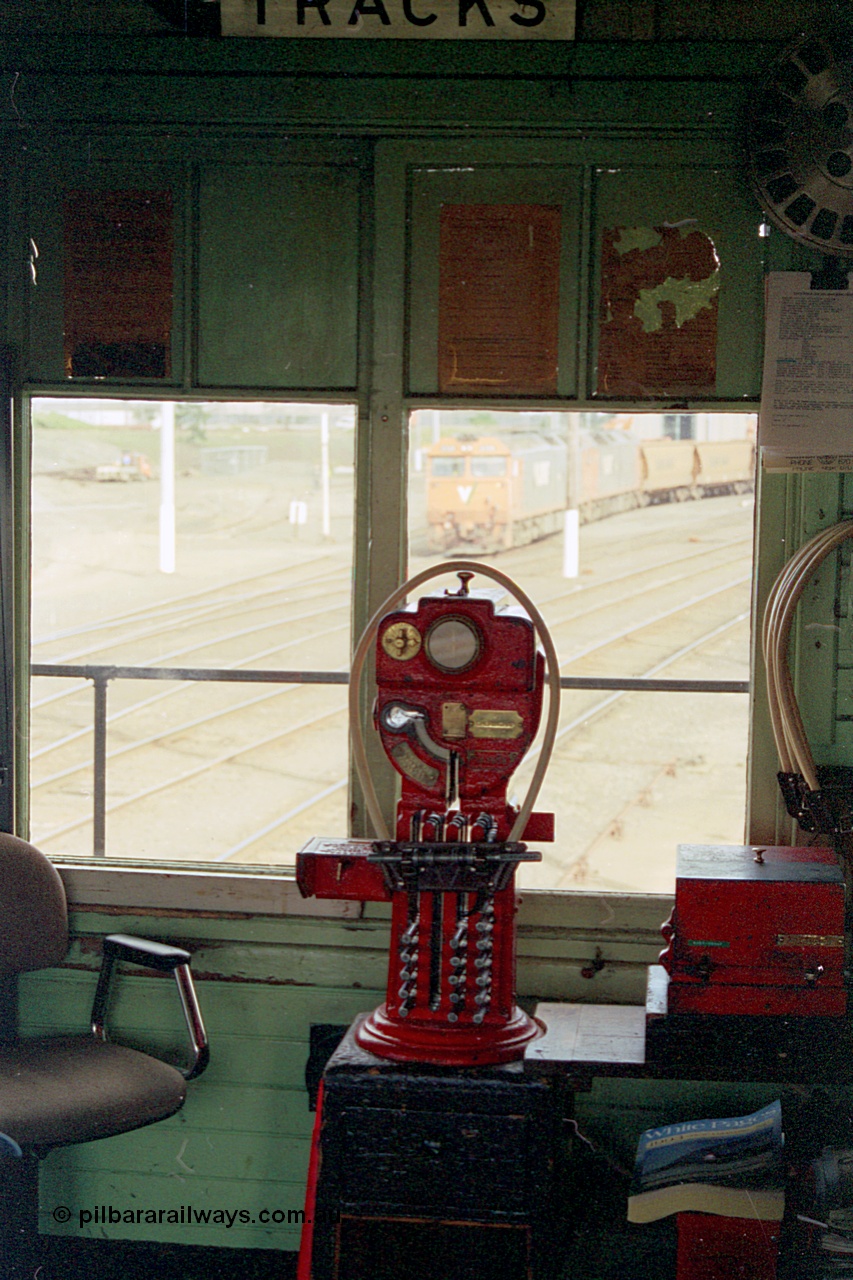 185-19
North Geelong C Signal Box, internal view of the miniature electric staff machine for the Gheringhap section with a staff ready in the hoop for V/Line grain train 9123 visible in the window.
