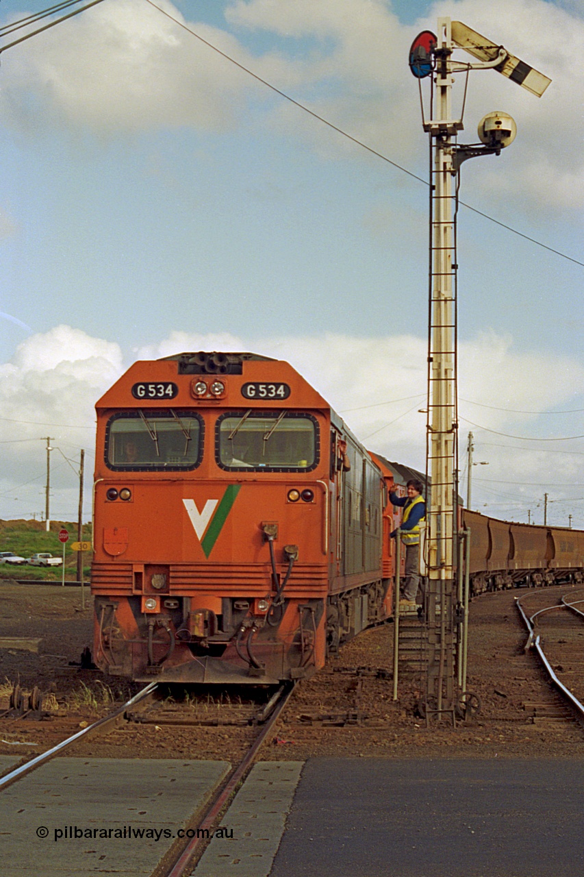 185-21
North Geelong C Box, Separation Street grade crossing, V/Line down grain train 9123 departing and having collected the electric staff for the Gheringhap section off the signaller at semaphore signal post 16 with motive power of G class G 534 Clyde Engineering EMD model JT26C-2SS serial 88-1264 leading G class leader G 511 serial 84-1239.
Keywords: G-class;G534;Clyde-Engineering-Somerton-Victoria;EMD;JT26C-2SS;88-1264;