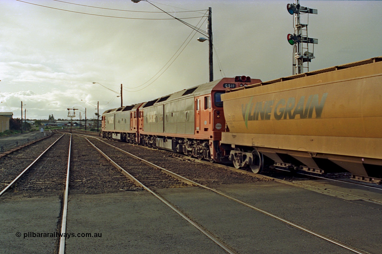 185-22
North Geelong C Box, Separation Street grade crossing, V/Line down grain train 9123 departing behind a pair of G classes G 534 Clyde Engineering EMD model JT26C-2SS serial 88-1264 leading class leader G 511 serial 84-1239, trailing view looking towards the grain arrivals roads and Gheringhap.
Keywords: G-class;G534;Clyde-Engineering-Somerton-Victoria;EMD;JT26C-2SS;88-1264;