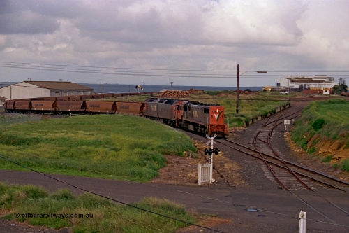 185-10
North Geelong Grain Loop view from Corio Quay Road across Access Road grade crossing, with the grain train behind V/Line locos X class locomotive X 41 Clyde Engineering EMD model G26C serial 70-704 long end leading and G class locomotive G 528 Clyde Engineering EMD model JT26C-2SS serial 88-1258 having past the Home Signal and about to pass the former tracks for the former Freezing Works Sidings.
Keywords: X-class;X41;Clyde-Engineering-Granville-NSW;EMD;G26C;70-704;