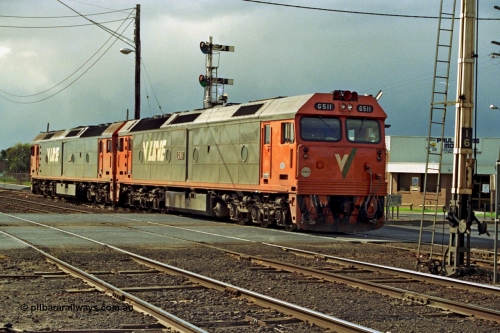 185-16
North Geelong C Box, Separation Street grade crossing, V/Line light engines, G class leader G 511 Clyde Engineering EMD model JT26C-2SS serial 84-1239 and younger sister G 534 serial 88-1264 shunt from the Gheringhap line back into North Geelong Yard past semaphore signal post 14, the disc signal can be just seen to be pulled off.
Keywords: G-class;G511;Clyde-Engineering-Rosewater-SA;EMD;JT26C-2SS;84-1239;