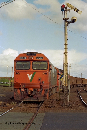 185-21
North Geelong C Box, Separation Street grade crossing, V/Line down grain train 9123 departing and having collected the electric staff for the Gheringhap section off the signaller at semaphore signal post 16 with motive power of G class G 534 Clyde Engineering EMD model JT26C-2SS serial 88-1264 leading G class leader G 511 serial 84-1239.
Keywords: G-class;G534;Clyde-Engineering-Somerton-Victoria;EMD;JT26C-2SS;88-1264;