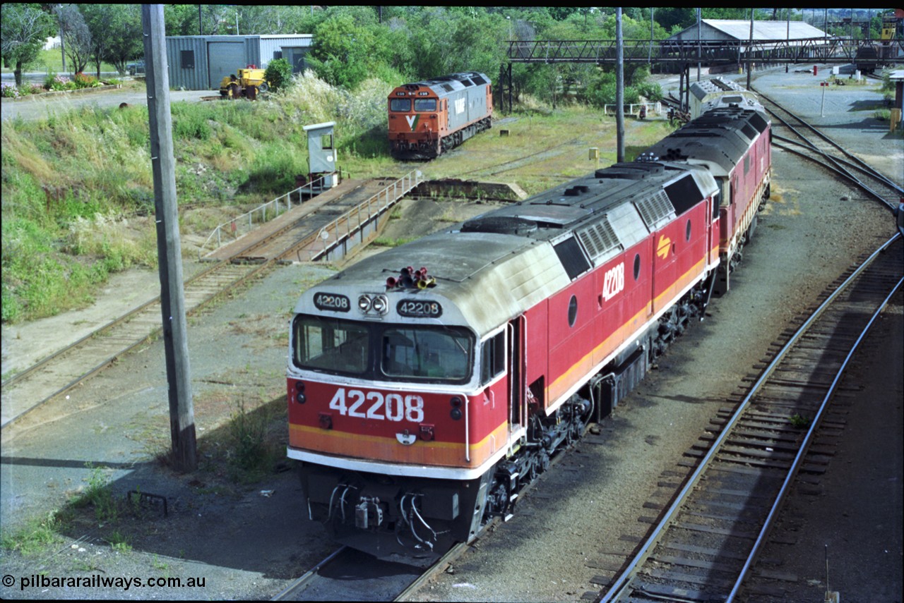 189-20
Albury, NSWSRA standard gauge loco depot with 422 class 42208 Clyde Engineering EMD model J26C serial 69-663 coupled to an 81 class and interloper V/Line G class G 519 Clyde Engineering EMD model JT26C-2SS serial 85-1232 rests off the turntable road, former trans-shipping shed in the background.
Keywords: 422-class;42208;Clyde-Engineering-Granville-NSW;EMD;J26C;69-663;