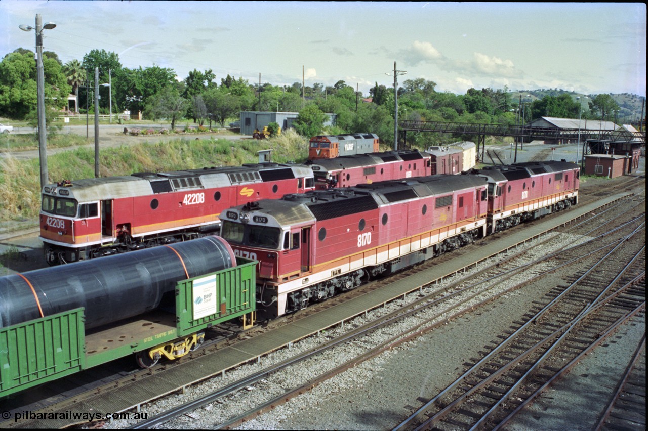 189-21
Albury yard view with a stabled Victorian bound goods train with dual 81 class units 8178 Clyde Engineering EMD model JT26C-2SS serial 85-1097 and 8170 serial 85-1089 on the point with 422 class 42208 Clyde Engineering EMD model J26C serial 69-663 and another 81 class 8169 all in the NSWSRA candy livery and Victorian interloper V/Line G class G 519 also a Clyde Engineering EMD model JT26C-2SS serial 85-1232 in the background on the turntable radial roads, Albury Station Signal Box and former trans-shipping shed visible at the far right.
Keywords: 81-class;8170;Clyde-Engineering-Kelso-NSW;EMD;JT26C-2SS;85-1089;