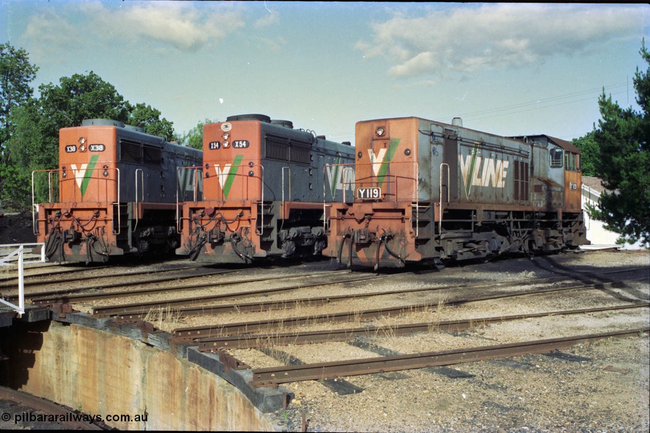 189-33
Wodonga, loco depot turntable radial roads, V/Line broad gauge locos lined up, 2nd series X class X 38 Clyde Engineering EMD model G26C serial 70-701 and 3rd series X class X 54 serial 75-801 with Y class Y 119 Clyde Engineering EMD model G6B serial 63-309, all long hood facing camera.
Keywords: Y-class;Y119;Clyde-Engineering-Granville-NSW;EMD;G6B;63-309;