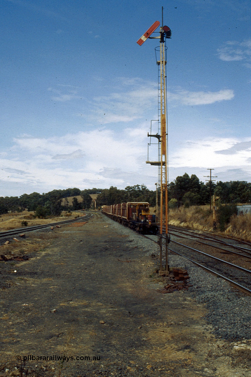 191-19
Kilmore East station environs, looking south, Signal Post 5 Up Home, UP special sleeper discharge train heading south with Signal Post 2 Up Starting visible in the distance, Down Refuge Siding on the right with Signal Post 4.
