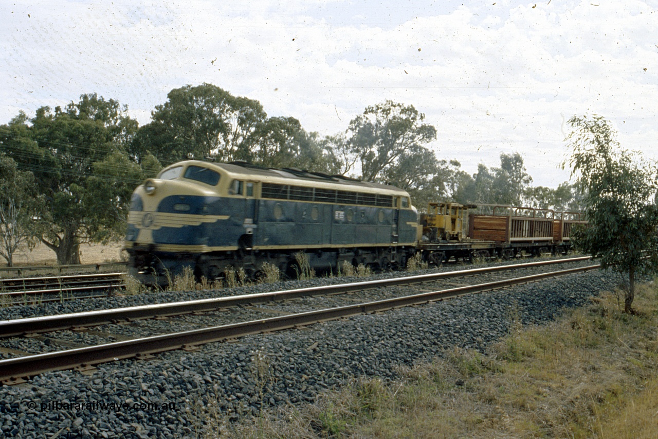 191-23
Wandong, O'Gradys Road grade crossing, near former Mathiesons Siding, Victorian Railways liveried B class B 65 Clyde Engineering EMD model ML2 serial ML2-6 leads an UP special sleeper discharge train as it discharges sleepers.
Keywords: B-class;B65;Clyde-Engineering-Granville-NSW;EMD;ML2;ML2-6;bulldog;