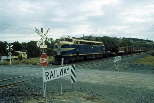 191-22
Wandong, O'Gradys Road grade crossing, near former Mathiesons Siding, Victorian Railways liveried B class B 65 Clyde Engineering EMD model ML2 serial ML2-6 leads an UP special sleeper discharge train as it discharges sleepers.
Keywords: B-class;B65;Clyde-Engineering-Granville-NSW;EMD;ML2;ML2-6;bulldog