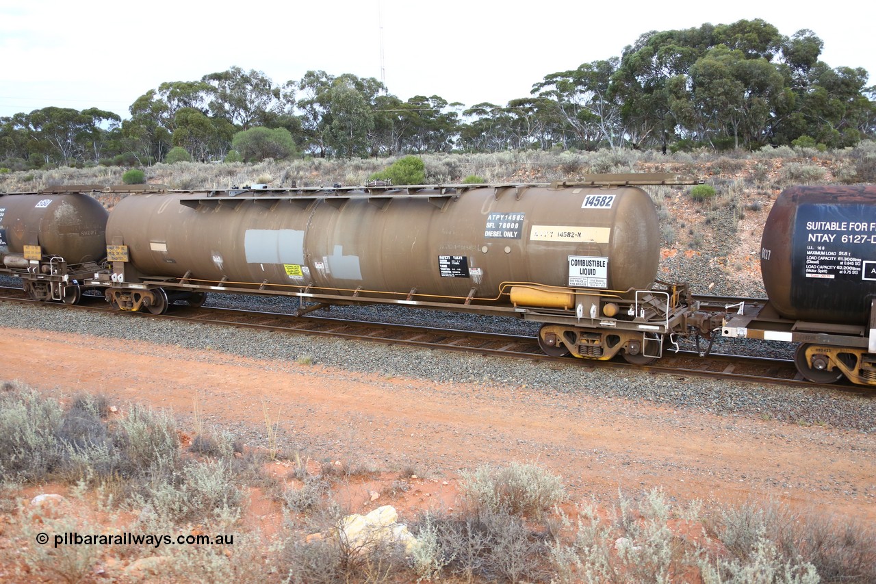161116 5118
West Kalgoorlie, Shell fuel train 3442, tank waggon ATPY 14582, built by Westrail Midland Workshops 1976 as narrow gauge type JPA, one of eight, in 1985 recoded to JPAA and then WJPA on SG. Fitted with type F InterLock couplers.
Keywords: ATBY-type;ATBY14582;Westrail-Midland-WS;JPA-type;JPAA-type;WJPA-type;