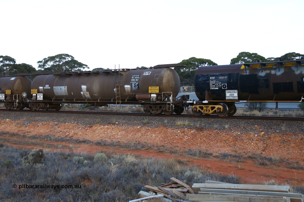 161116 5555
Binduli, empty Shell fuel train 4443, ATPF type fuel tank waggon ATPF 576, built by WAGR Midland Workshops 1974 for Shell as WJP type, 80.66 kL one compartment one dome, fitted with type F InterLock couplers and still with ladder.
Keywords: ATPF-type;ATPF576;WAGR-Midland-WS;WJP-type;