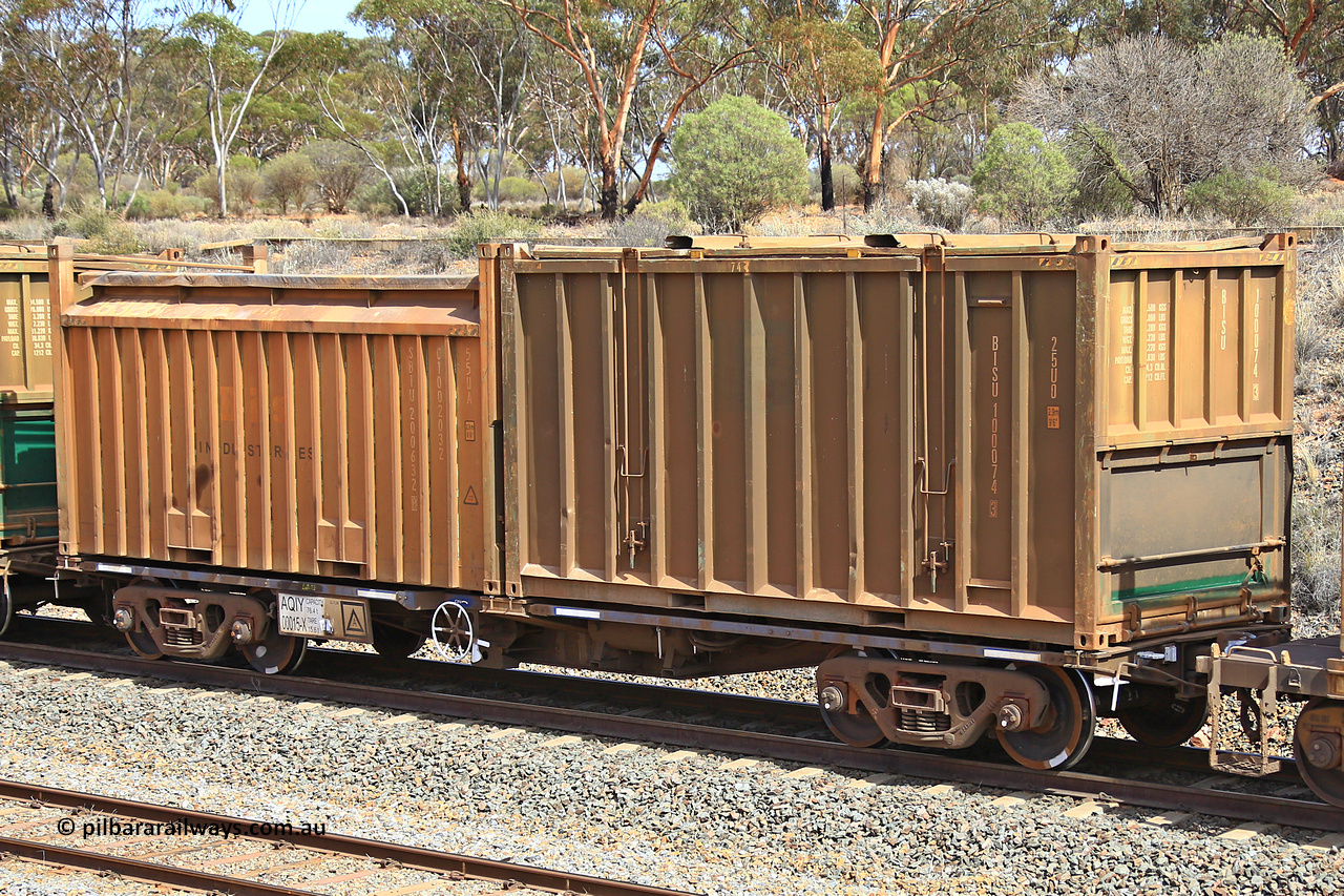 231020 8271
Binduli, 5029 Malcolm Freighter, AQIY type 40' container waggon AQIY 00015 with an undecorated Bis Industries hard-top 25U0 type sulphur containers BISU 100074 and a Bis Industries 55UA roll-top sulphur container SIBU 200632. The AQIY started life built by Bradken and coded CQYY but CFCLA never bought them, so Bradken coded them KQYY and stored them. When Aurizon bought them they had the handbrake relocated to the middle of the waggon from the end.
Keywords: AQIY-type;AQIY00015;Bradken;CQYY-type;KQYY-type;