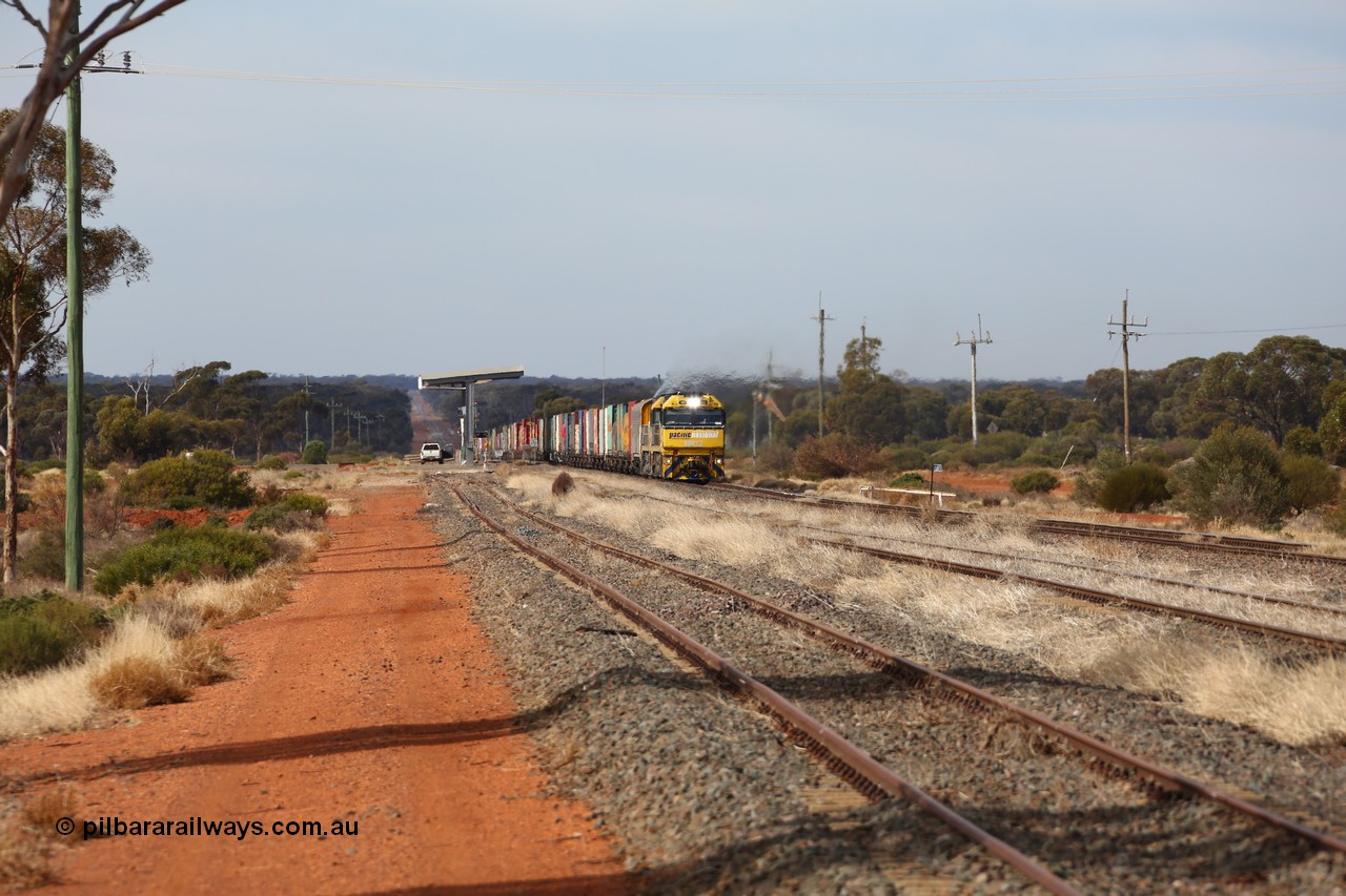 160523 2925
Parkeston, 7SP3 intermodal train, a pair of Goninan built GE model Cv40-9i NR class units NR 12 serial 7250-02/97-214 and NR 51 serial 7250-08/97-253 lead the train 'elephant style' out of the dip and along the mainline at the 1776 km. The PN local is in the car at the gantry performing a roll-by, the track on the left is the Engineers Siding.
Keywords: NR-class;NR12;Goninan;GE;Cv40-9i;7250-02/97-214;