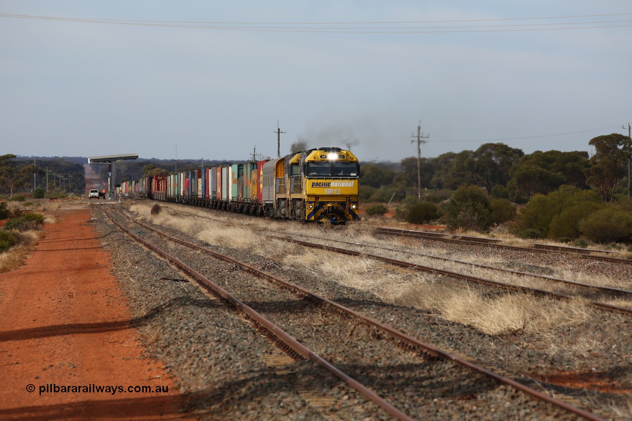 160523 2926
Parkeston, 7SP3 intermodal train, a pair of Goninan built GE model Cv40-9i NR class units NR 12 serial 7250-02/97-214 and NR 51 serial 7250-08/97-253 lead the train 'elephant style' out of the dip and along the mainline at the 1776 km. The PN local is in the car at the gantry performing a roll-by, the track on the left is the Engineers Siding.
Keywords: NR-class;NR12;Goninan;GE;Cv40-9i;7250-02/97-214;