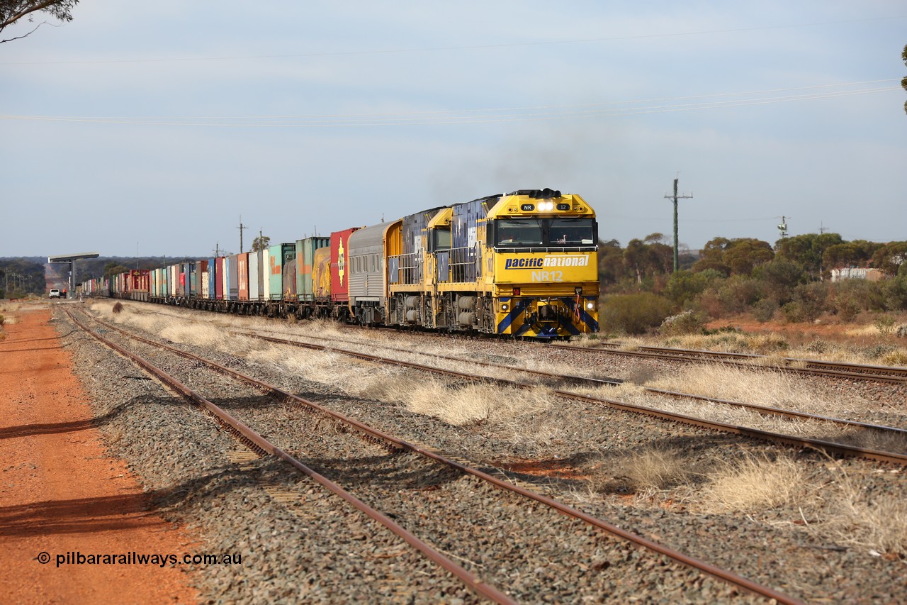 160523 2927
Parkeston, 7SP3 intermodal train, a pair of Goninan built GE model Cv40-9i NR class units NR 12 serial 7250-02/97-214 and NR 51 serial 7250-08/97-253 lead the train 'elephant style' out of the dip and along the mainline at the 1776 km. The PN local is in the car at the gantry performing a roll-by, the track on the left is the Engineers Siding.
Keywords: NR-class;NR12;Goninan;GE;Cv40-9i;7250-02/97-214;