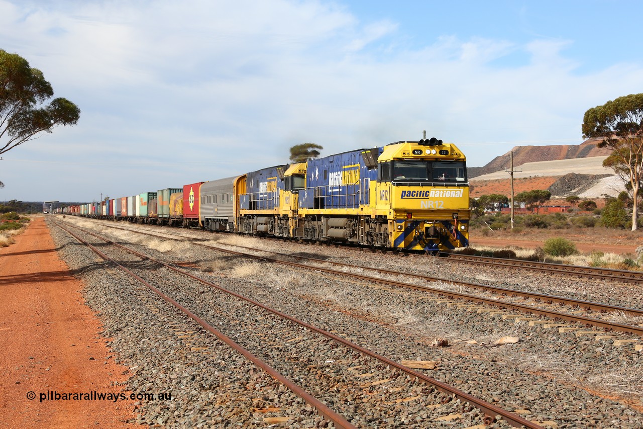 160523 2929
Parkeston, 7SP3 intermodal train, a pair of Goninan built GE model Cv40-9i NR class units NR 12 serial 7250-02/97-214 and NR 51 serial 7250-08/97-253 lead the train 'elephant style' out of the dip and along the mainline at the 1776 km. The PN local is in the car at the gantry performing a roll-by, the track on the left is the Engineers Siding.
Keywords: NR-class;NR12;Goninan;GE;Cv40-9i;7250-02/97-214;