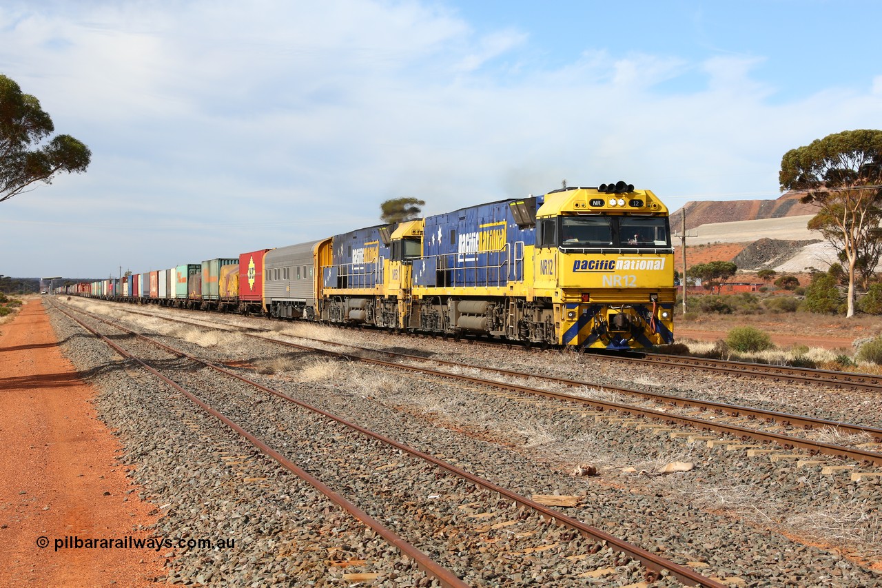 160523 2930
Parkeston, 7SP3 intermodal train, a pair of Goninan built GE model Cv40-9i NR class units NR 12 serial 7250-02/97-214 and NR 51 serial 7250-08/97-253 lead the train 'elephant style' out of the dip and along the mainline at the 1776 km. The PN local is in the car at the gantry performing a roll-by, the track on the left is the Engineers Siding.
Keywords: NR-class;NR12;Goninan;GE;Cv40-9i;7250-02/97-214;