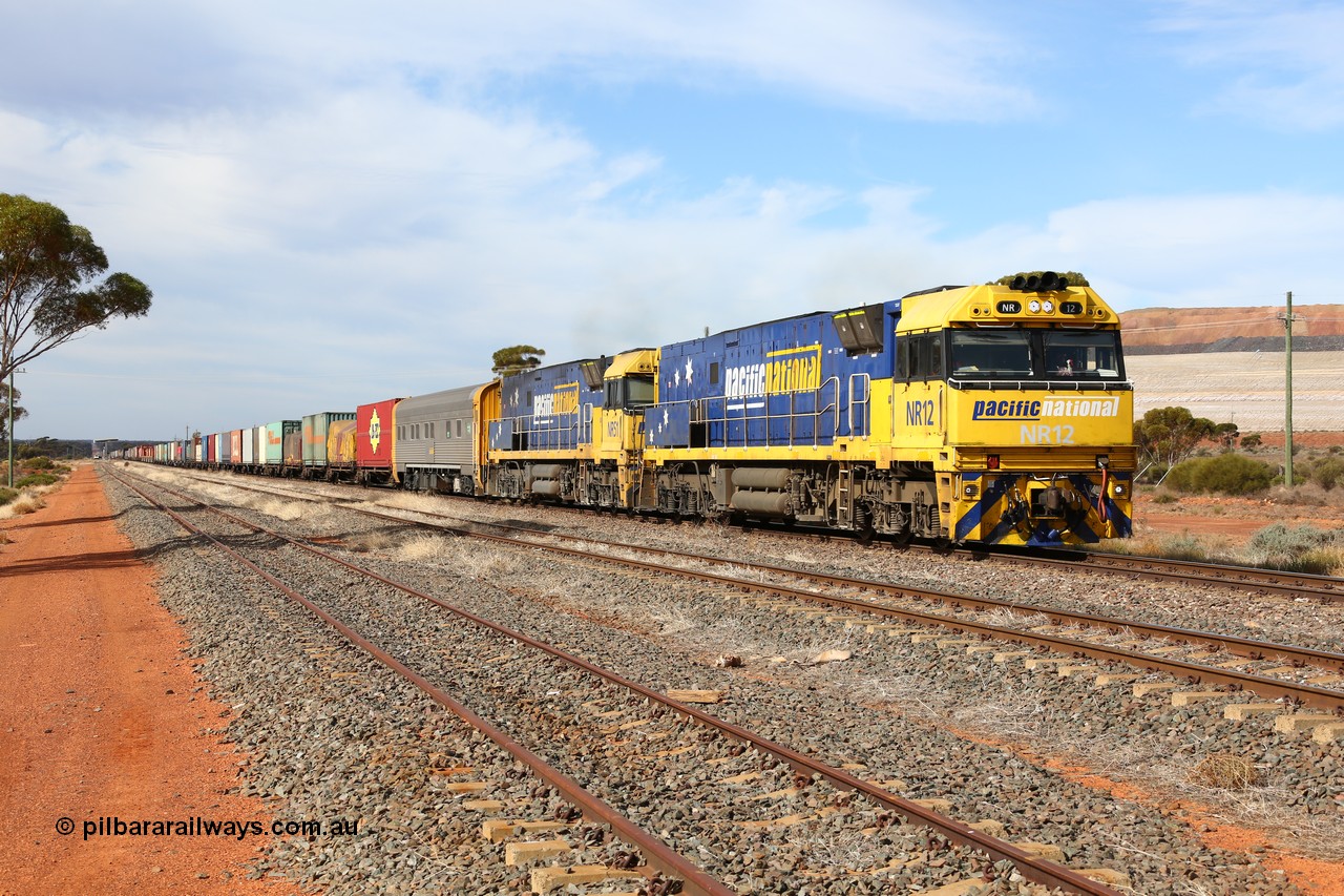 160523 2931
Parkeston, 7SP3 intermodal train, a pair of Goninan built GE model Cv40-9i NR class units NR 12 serial 7250-02/97-214 and NR 51 serial 7250-08/97-253 lead the train 'elephant style' out of the dip and along the mainline at the 1776 km. The PN local is in the car at the gantry performing a roll-by, the track on the left is the Engineers Siding.
Keywords: NR-class;NR12;Goninan;GE;Cv40-9i;7250-02/97-214;