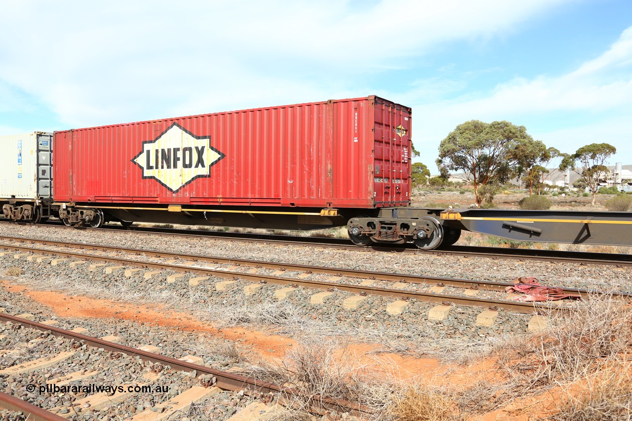 160523 2971
Parkeston, 7SP3 intermodal train, RRQY 8519 platform 5 of 5-pack articulated skel waggon set, built by Qiqihar Rollingstock Works, China, loaded with a 48' Linfox container DRC 841.
Keywords: RRQY-type;RRQY8519;Qiqihar-Rollingstock-Works-China;