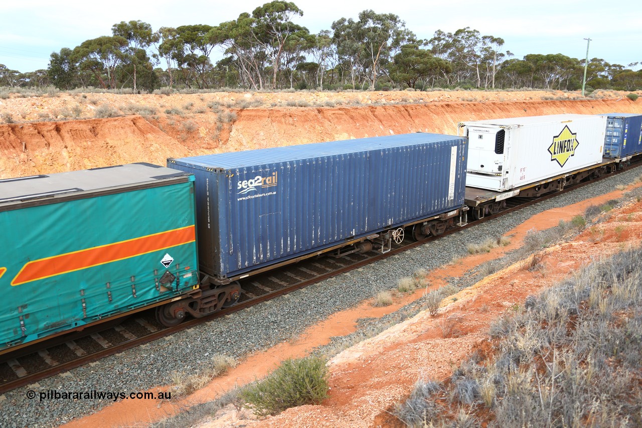 160524 3779
West Kalgoorlie, 2PM6 intermodal train, RQLY 4 platform 1 of 5-pack articulated skeletal waggon set, 1 of 8 built by AN Rail Islington Workshops in 1987 as AQJY, SCF sea2rail 40' box SCFU 408239.
Keywords: RQJY-type;RQJY4;AN-Islington-WS;AQJY-type;