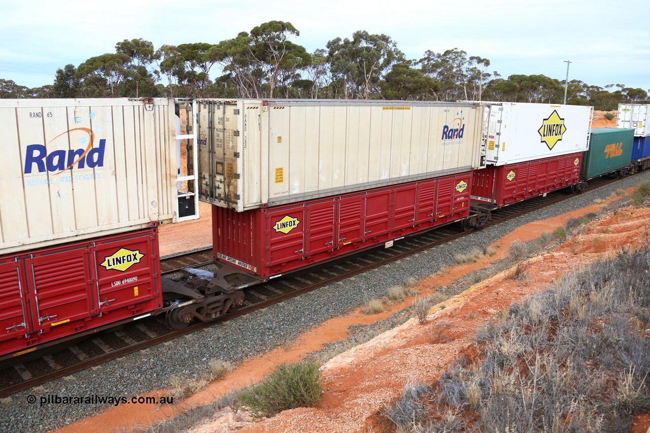 160524 3797
West Kalgoorlie, 2PM6 intermodal train, RRGY 7125 platform 3 of 5-pack articulated skeletal waggon set, one of fifty originally built by AN Rail Islington Workshops in 1996-97 as type RRBY, later rebuilt with 48' intermediate decks and recoded to RRGY, with a Linfox 40' half height side door LSDU 6940054 double stacked with a RAND Refrigerated Logistics 46' MFR3 type reefer RAND 380.
Keywords: RRGY-type;RRGY7125;AN-Islington-WS;RRBY-type;