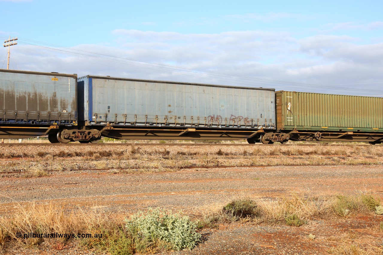 160525 4456
Parkeston, 3PM7 priority service train, RRQY 8408 platform 4 of 5-pack articulated skel waggon, one of thirty four sets built by Qiqihar Rollingstock Works China in 2012, 48' deck with a Pacific National 48' curtainsider PNXM 4522.
Keywords: RRQY-type;RRQY8408;Qiqihar-Rollingstock-Works-China;