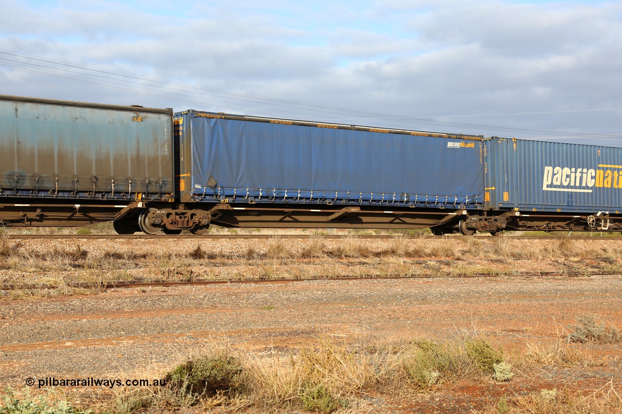 160525 4529
Parkeston, 3PM7 priority service train, RRQY 8344 platform 2 of 5-pack articulated skel waggon set the last of a batch of 41 built by Qiqihar Rollingstock Works China in 2005 for Pacific National, with a Pacific National 48' curtainsider PNXM 5203.
Keywords: RRQY-type;RRQY8344;Qiqihar-Rollingstock-Works-China;