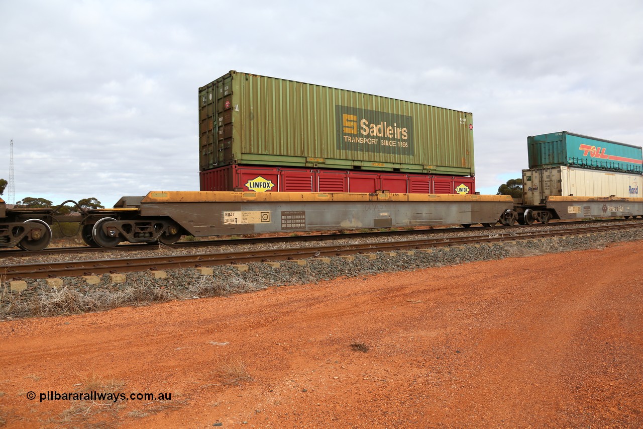 160529 8768
Parkeston, 6MP4 intermodal train, RRZY 7049 platform 2 of 5-pack well waggon set, one of thirty two sets built by Goninan NSW in 1995-96 for National Rail as RQZY type, recoded to RRZY when repaired, with a Linfox 40' half height LSDU side door container and a 40' 4EG1 type box RCS 4130.
Keywords: RRZY-type;RRZY7049;Goninan-NSW;RQZY-type;