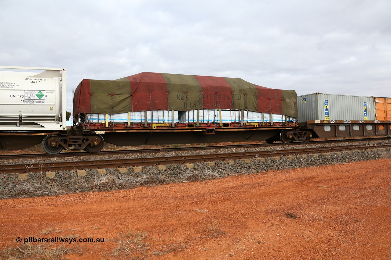 160529 8784
Parkeston, 6MP4 intermodal train, RQLY 1007 an articulated five unit container waggon with centre well, one of a batch of fourteen built by AN Rail Islington Workshops in 1991 as AQLY type, platform 4 loaded with K&S 40' flatrack KT 32 and tarped with timber products.
Keywords: RQLY-type;RQLY1007;AN-Islington-WS;AQLY-type;