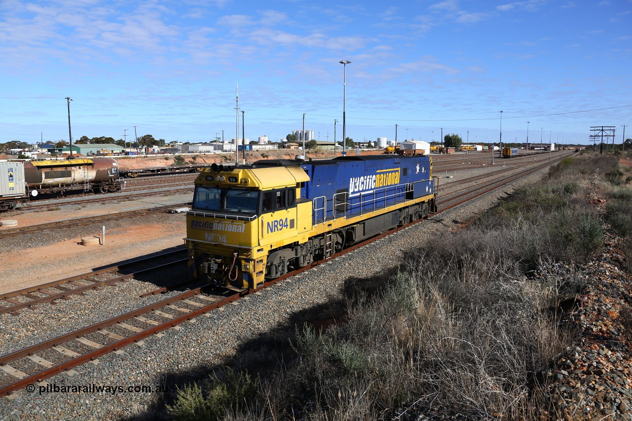 160531 9881
West Kalgoorlie, Pacific National's Goninan built GE model Cv40-9i NR class unit NR 94 serial 7250-06/97-300, shunts off 3PM4 steel train to collect the loading and crew coach sitting in the yard. 31st of May 2016.
Keywords: NR-class;NR94;Goninan;GE;Cv40-9i;7250-06/97-300;