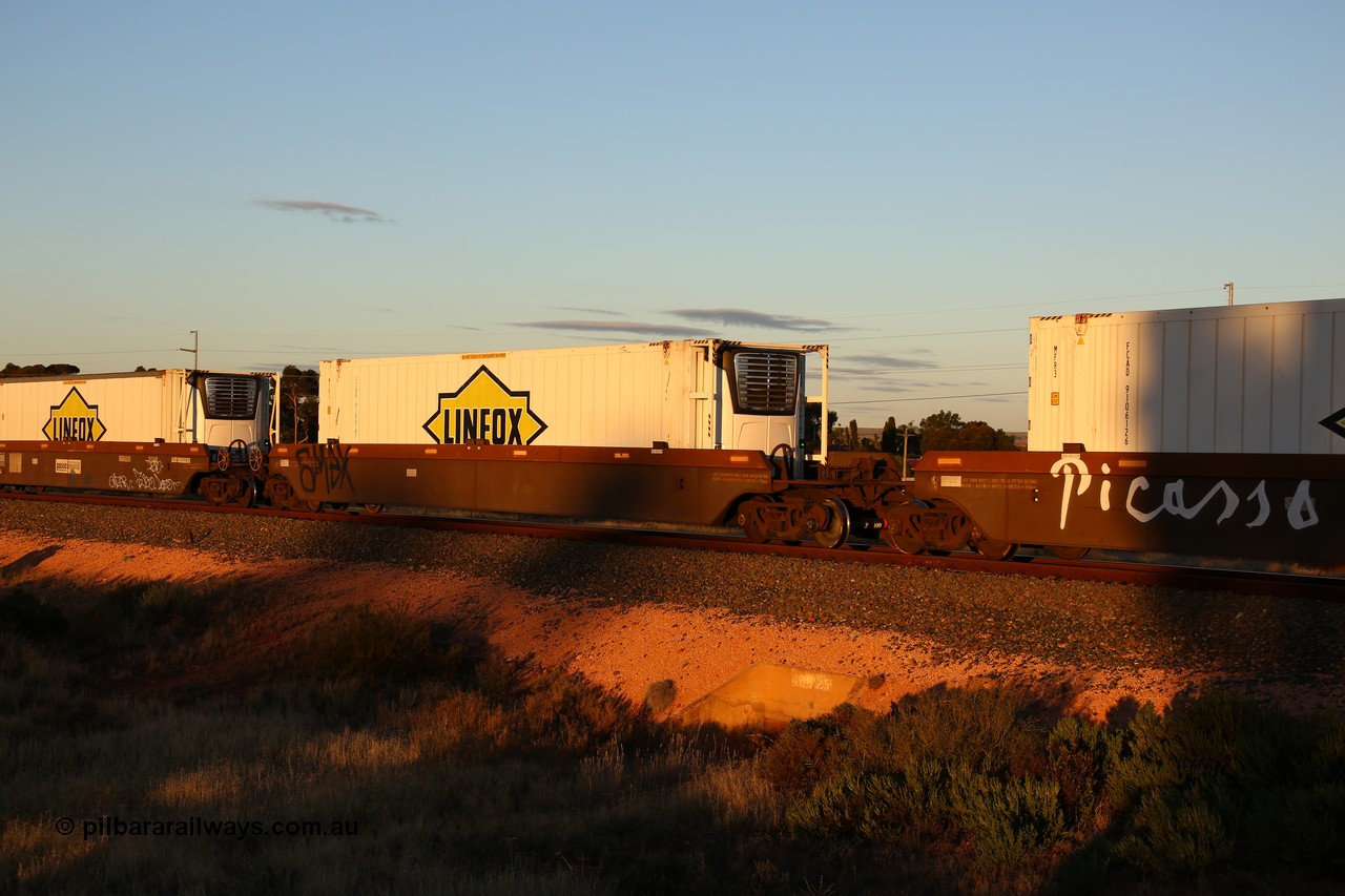 160601 10104
West Kalgoorlie, 2MP5 intermodal train, platform 2 of 5-pack RRRY 7011 well waggon set, one of nineteen built in China at Zhuzhou Rolling Stock Works for Goninan in 2005, Linfox 46' reefer FCAD 910614.
Keywords: RRRY-type;RRRY7011;CSR-Zhuzhou-Rolling-Stock-Works-China;