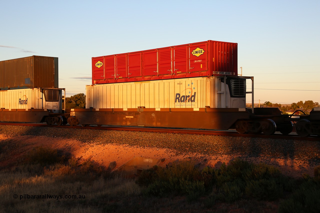 160601 10146
West Kalgoorlie, 2MP5 intermodal train, RRZY 7008 platform 2 of 5-pack well waggon set, the prototype of the RQZY type, first of twenty six sets built by Goninan in 1995-96 for National Rail, later rebuilt and recoded RRZY with a 46' RAND Refrigerated Logistics reefer RAND 260 and a Linfox 40' half height side door container LSDU 694007 on top.
Keywords: RRZY-type;RRZY7008;Goninan-NSW;RQZY-type;