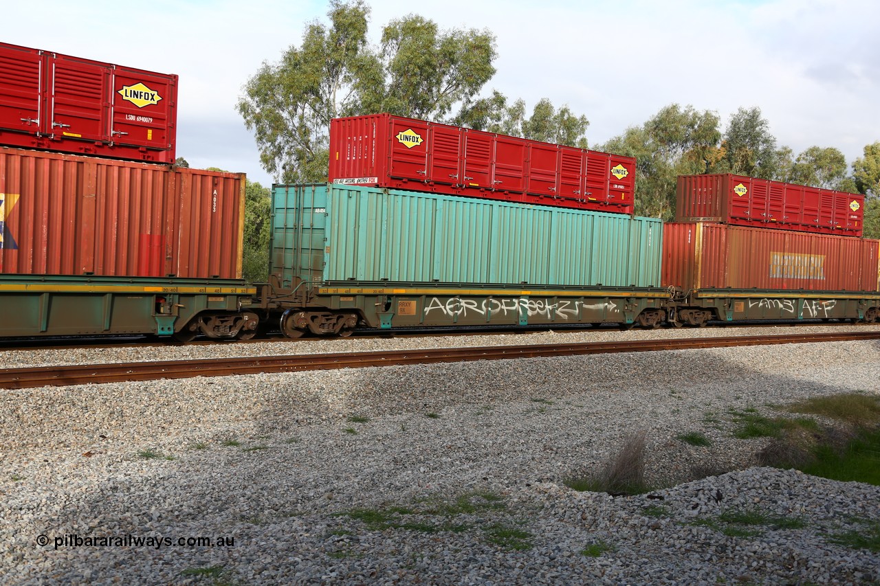 160609 0424
Woodbridge, 5PM5 intermodal train, RRXY 9 platform 2 of 5-pack well waggon set, one of eleven built by Bradken Qld in 2002 for Toll from a Williams-Worley design with a 53' Toll green automobile box AB 054 with a 40' Linfox half height side door unit LSDU 694005 on top.
Keywords: RRXY-type;RRXY9;Williams-Worley;Bradken-Rail-Qld;