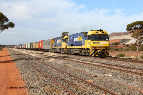 160523 2930
Parkeston, 7SP3 intermodal train, a pair of Goninan built GE model Cv40-9i NR class units NR 12 serial 7250-02/97-214 and NR 51 serial 7250-08/97-253 lead the train 'elephant style' out of the dip and along the mainline at the 1776 km. The PN local is in the car at the gantry performing a roll-by, the track on the left is the Engineers Siding.
Keywords: NR-class;NR12;Goninan;GE;Cv40-9i;7250-02/97-214;