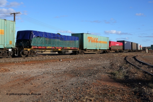 160528 8339
Parkeston, 5SP5 intermodal train, RRQY 8523 the final unit of a batch of twenty five five pack articulated waggon sets built in 2015 by Qiqihar Rollingstock Works in China. Seen here loaded with a K&S 40' flatrack KT 400233 with a John Stepnell Transport tarped load, 48' Toll TCML 48533, K&S 40' flatrack and two 40' containers.
Keywords: RRQY-type;RRQY8523;Qiqihar-Rollingstock-Works-China;