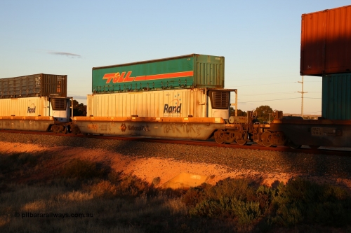 160601 10111
West Kalgoorlie, 2MP5 intermodal train, RQZY 7065 platform 5 of 5-pack well waggon set one of thirty two waggon sets built by Goninan NSW for National Rail in 1995-96, double stacked with a Toll 40' half height curtainsider 5TC 209 and Rand Refrigerated Logistics 46' 6