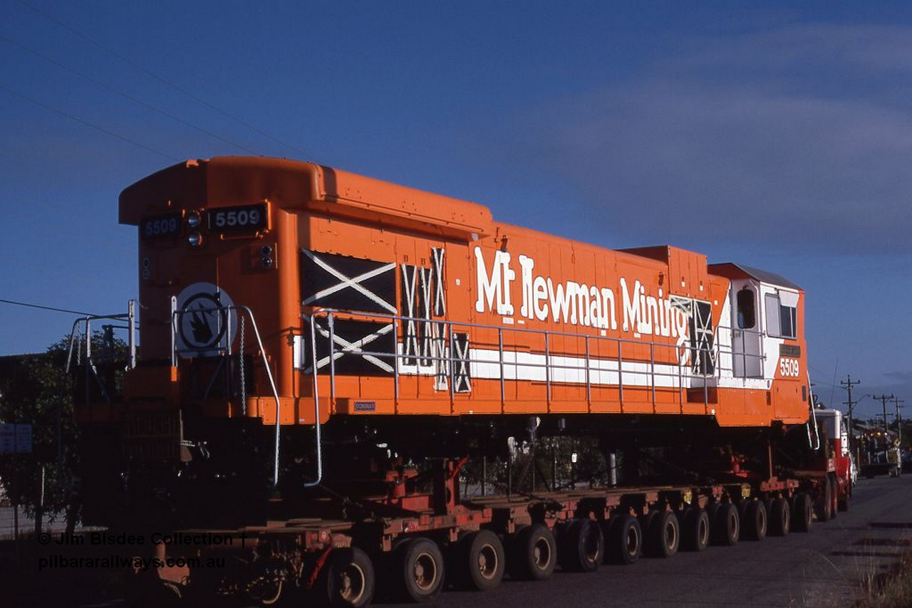 1062 001
Welshpool, Goninan, Mt Newman Mining's GE C36-7M rebuild unit 5509 serial 4839-05 / 87-074 being road hauled to Port Hedland by Bell on a ninety four wheel float. This unit was rebuild from AE Goodwin ALCo C636 unit 5452 serial G6012-1. May 1987.
Jim Bisdee photo.
Keywords: 5509;Goninan;GE;C36-7M;4839-05/87-074;rebuild;AE-Goodwin;ALCo;C636;5452;G6012-1;