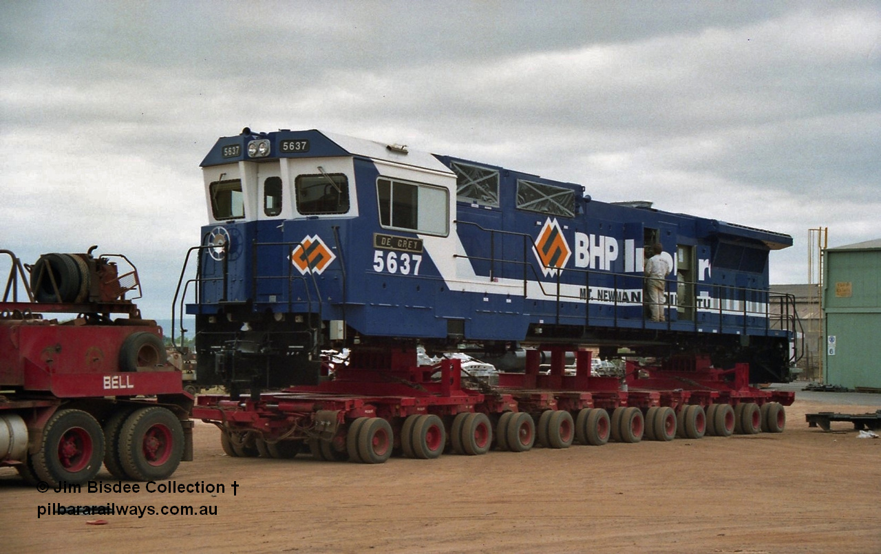 20846
Bassendean, Goninan workshops, newly completed BHP Iron Ore CM40-8M rebuild unit 5637 'De Grey' serial 8181-01 / 92-123 sits on a Bell road transport float bound for Port Hedland. 5637 was rebuilt from AE Goodwin ALCo C636 unit 5456 serial G6012-5. January 1992 image.
Jim Bisdee photo.
Keywords: 5637;Goninan;GE;CM40-8M;8181-01/92-123;rebuild;AE-Goodwin;ALCo;C636;5456;G6012-5;