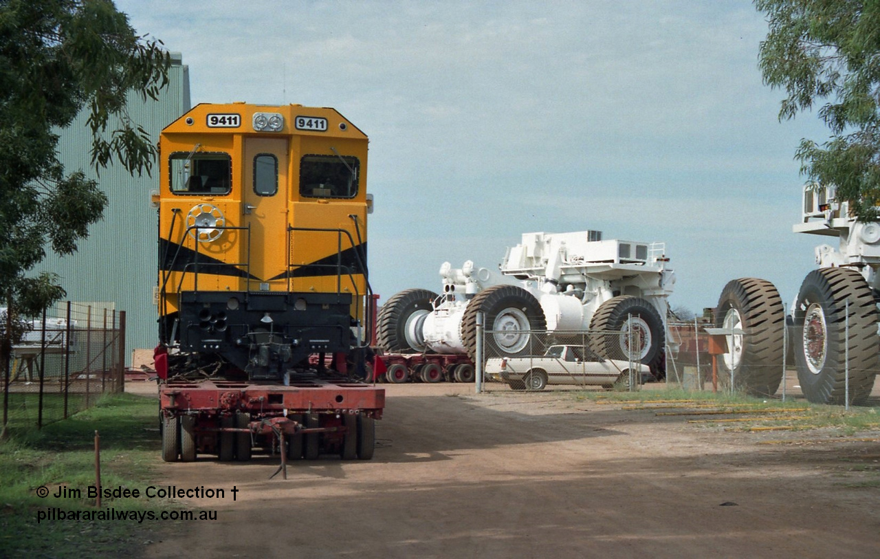 20955
Bassendean, Goninan workshops, sitting outside the gates waiting to head to Cape Lambert, Robe River Goninan GE CM40-8M rebuild unit 9411 serial 8206-02 / 92-125, retains its original Robe River road number on a hundred and twenty wheel road float. 9411 was rebuilt into the GE CM40-8M unit from AE Goodwin ALCo M636 serial G6060-2. February 1992.
Jim Bisdee photo.
Keywords: 9411;Goninan;GE;CM40-8M;8206-02/92-125;rebuild;AE-Goodwin;ALCo;M636;G6060-2;