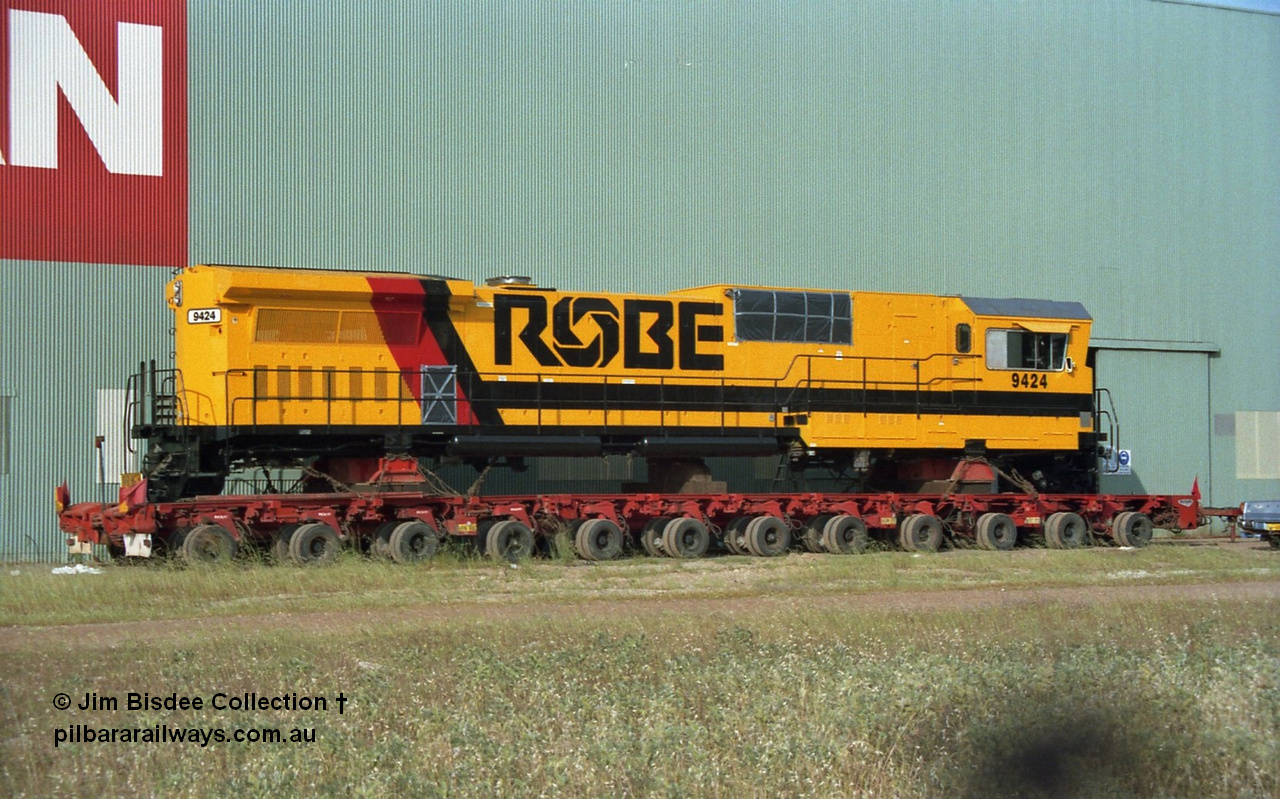 22350
Bassendean, Goninan workshops, loaded onto a ninety six wheel road transport float, Robe River rebuild GE CM40-8M unit 9424 serial 6266-07 / 89-84 is loaded awaiting transport to Cape Lambert. 9424 was rebuilt from former Spokane Portland & Seattle number 343 an ALCo Schenectady NY model C636 serial 6010-4, to Robe River in May 1981 as 9424, kept this number when rebuilt here. September 1991.
Jim Bisdee photo.
Keywords: 9424;Goninan;GE;CM40-8M;6266-7/89-84;rebuild;ALCo;Schenectady-NY;C636;BN4369;6010-4;