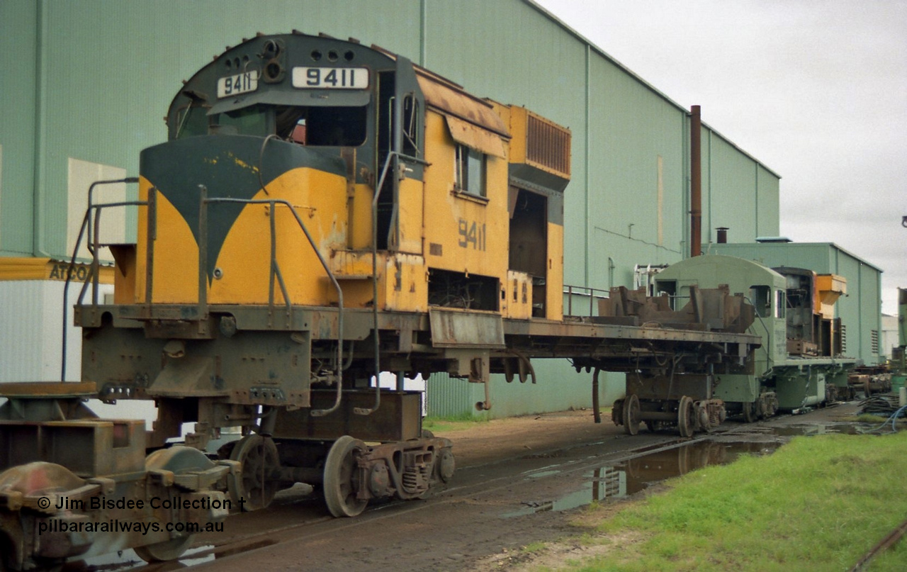 22653
Bassendean, during an Open Day at the Goninan workshops, Robe River's AE Goodwin built ALCo M636 model unit 9411 serial G6060-2 is in the middle of being rebuilt into a GE CM40-8M model. 9411 was built in July 1971, when delivered it carried road number 262.002, then following completion of the construction phase was re-numbered to 1711, before again being re-numbered to 9411. 20th July 1991.
Jim Bisdee photo.
Keywords: 9411;AE-Goodwin;ALCo;M636;G6060-2;262.002;1711;