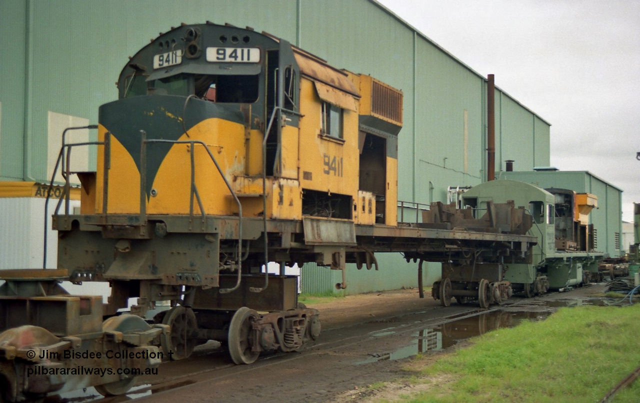 22653
Bassendean, during an Open Day at the Goninan workshops, Robe River's AE Goodwin built ALCo M636 model unit 9411 serial G6060-2 is in the middle of being rebuilt into a GE CM40-8M model. 9411 was built in July 1971, when delivered it carried road number 262.002, then following completion of the construction phase was re-numbered to 1711, before again being re-numbered to 9411. 20th July 1991.
Jim Bisdee photo.
Keywords: 9411;AE-Goodwin;MLW-ALCo;M636;G6060-2;262.002;1711;