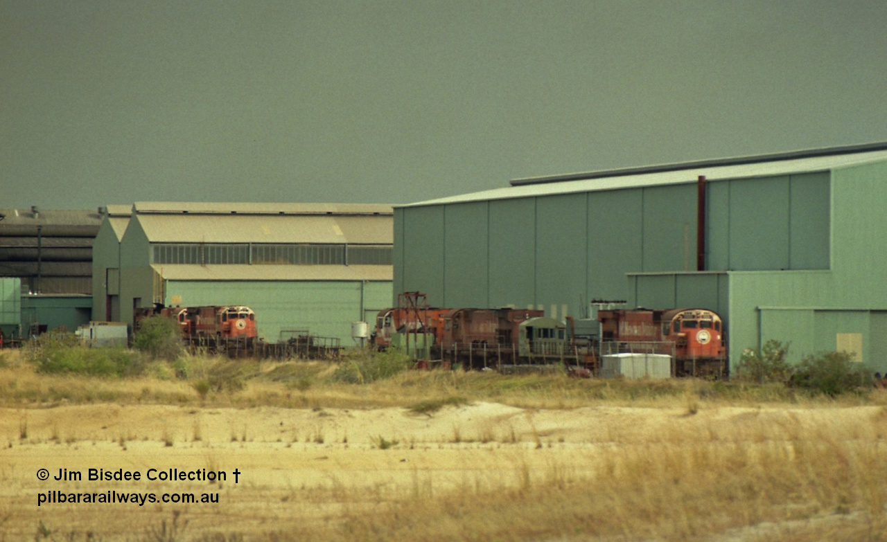 22927
Bassendean, Goninan workshops, view of several Mt Newman Mining ALCo units awaiting rebuilding or scrapping. November 1992.
Jim Bisdee photo.

