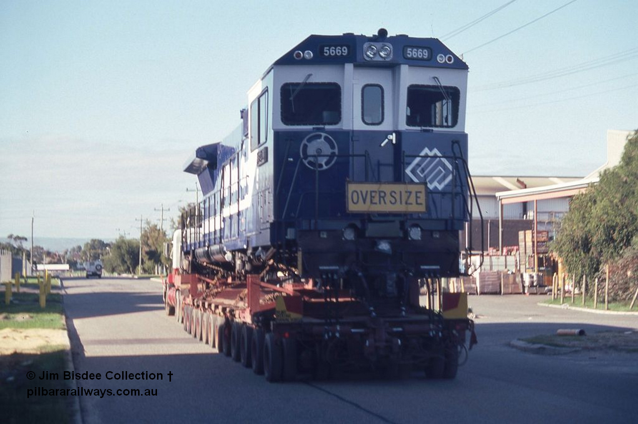 3585 001
Bassendean, Wood St, delivery of the final BHP CM40-8MEFI unit 5669 'Beilun' serial 8412-02 / 95-160. Unit was rebuilt as one of three with an electronic fuel injected prime mover by Goninan from Comeng built ALCo M636 unit 5486 serial C6084-2. Date July 1995.
Jim Bisdee photo.
Keywords: 5669;Goninan;GE;CM40-8EFI;8412-02/95-160;rebuild;Comeng-NSW;ALCo;M636C;5486;C6084-2;