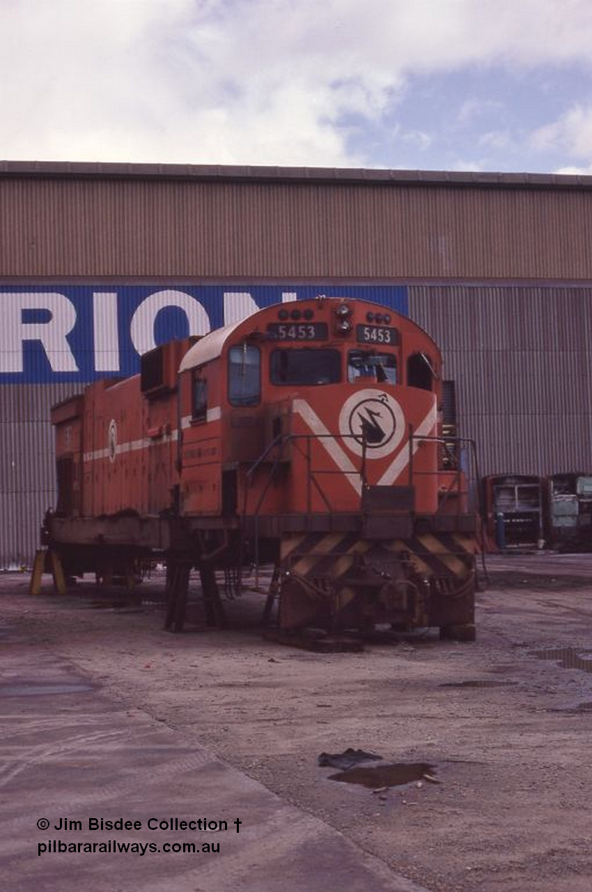 5944 001 Welshpool 1987April
Welshpool, Goninan workshops, Mt Newman Mining C636 ALCo unit 5453 serial G6012-2 built by AE Goodwin in 1969 is undergoing a world first as it gets rebuilt into a GE C36-7M locomotive. In this April 1987 view the process has started with the bogies and fuel tank removed. By February 1988 it would be the final C36-7M built for Mt Newman Mining as 5513. April 1987.
Jim Bisdee photo.
Keywords: 5453;AE-Goodwin;ALCo;C636;G6012-2;