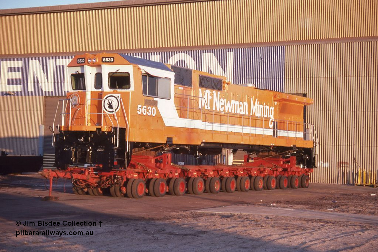6991 001 Welshpool 19880904
Welshpool, Goninan workshops, brand new Mt Newman Mining's GE model CM39-8 loco 5630 'Zeus' serial 5831-09 / 88-079 is lashed down on a road transport float ready for haulage to Port Hedland in this 4th September 1988 image.
Jim Bisdee photo.
Keywords: 5630;Goninan;GE;CM39-8;5831-09/88-079;