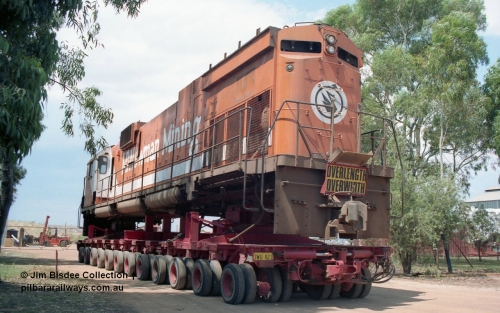 20860
Bassendean, Goninan workshops, sitting outside the locked gates having just been bought down from Port Hedland, Mt Newman Mining's AE Goodwin ALCo C636 unit 5454 serial G6012-3 on a ninety six wheel road float. 5454 will be rebuilt into CM40-8M unit 5641 by June 1992. Image taken January 1992.
Jim Bisdee photo.
Keywords: 5454;AE-Goodwin;ALCo;C636;G6012-3;