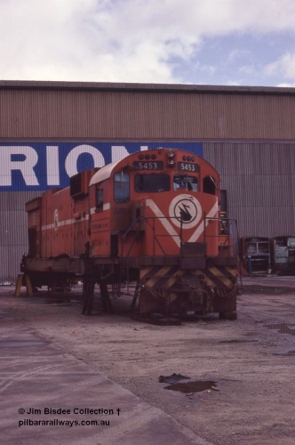 5944 001 Welshpool 1987April
Welshpool, Goninan workshops, Mt Newman Mining C636 ALCo unit 5453 serial G6012-2 built by AE Goodwin in 1969 is undergoing a world first as it gets rebuilt into a GE C36-7M locomotive. In this April 1987 view the process has started with the bogies and fuel tank removed. By February 1988 it would be the final C36-7M built for Mt Newman Mining as 5513. April 1987.
Jim Bisdee photo.
Keywords: 5453;AE-Goodwin;ALCo;C636;G6012-2;