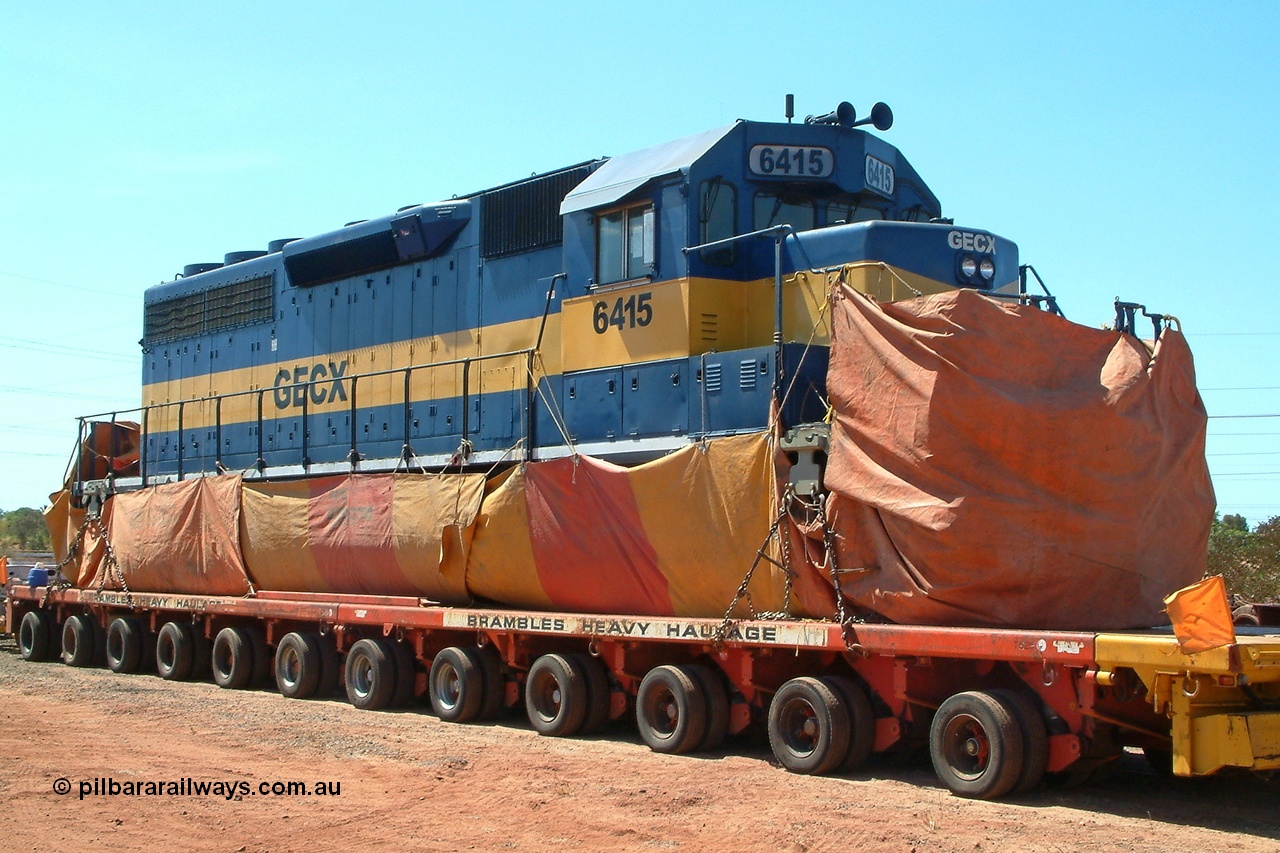 031109 140045r
Nelson Point, the first actual EMD SD40 model locomotive to arrive in Australia GECX 6415 serial 31542 frame 7861-52 built April 1966 for Southern Pacific as SP 8461 and still wearing previous owner IC & E blue and / yellow livery with 'fire cracker' aerial waits patiently on the back of a Brambles heavy-haul float with the tarp due to some quarantine issues and an officer from AQIS was in attendance as foreign soil had been found 9th November 2003.
Keywords: GECX6415;EMD;SD40;31542/7861-52;SP8461;