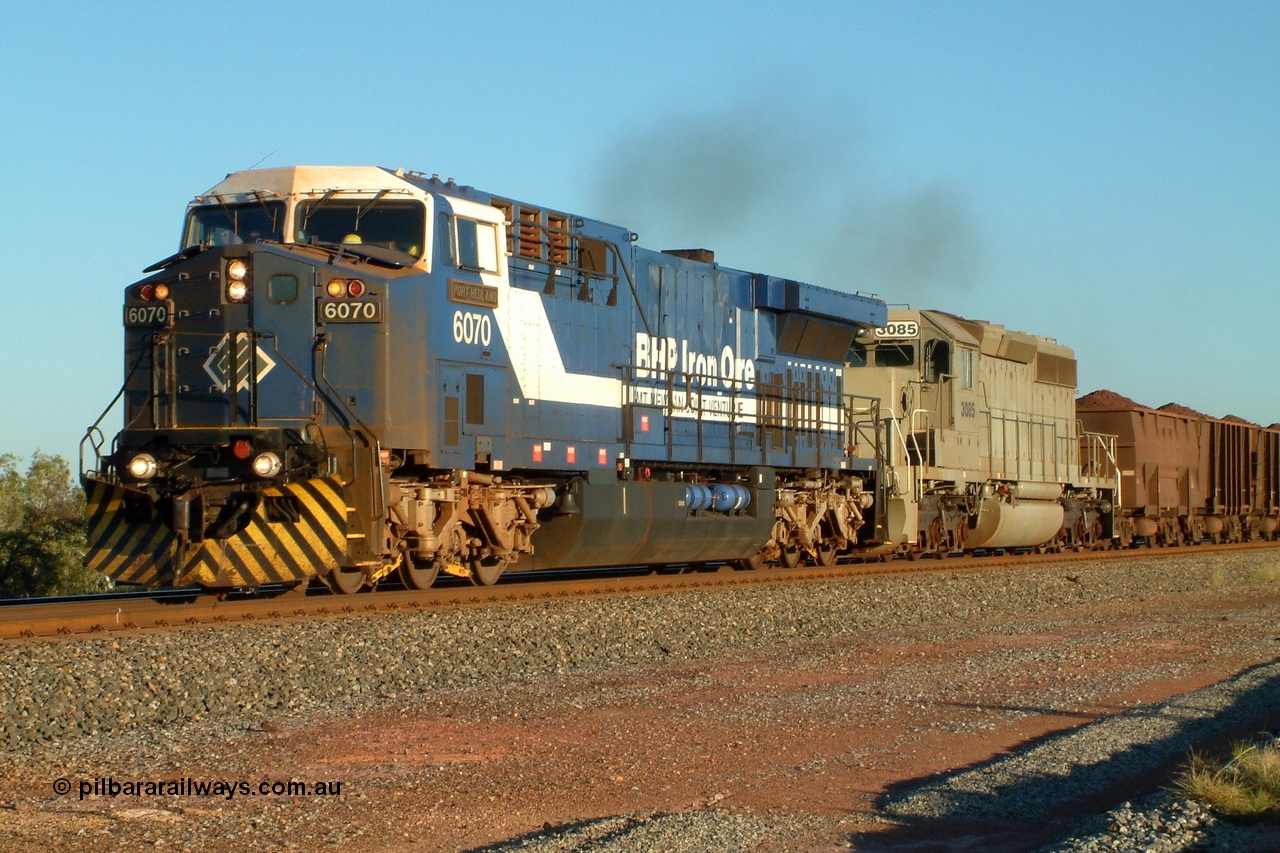 040507 170218r
Walla, BHP GE AC6000 locomotive class leader 6070 'Port Hedland' serial 51062 leads EMD built model SD40-2 unit 3085 serial 786170-25, former Union Pacific UP 3523, as they power up out of Walla siding having had an empty train cross pass, 7th May 2004.
Keywords: 6070;GE;AC6000;51062;